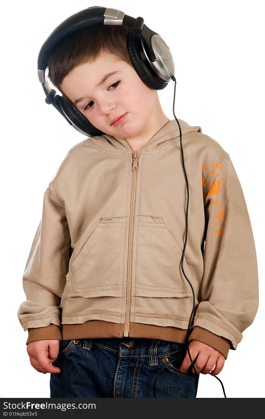 Boy listening to music on headphones isolated on white. Boy listening to music on headphones isolated on white.