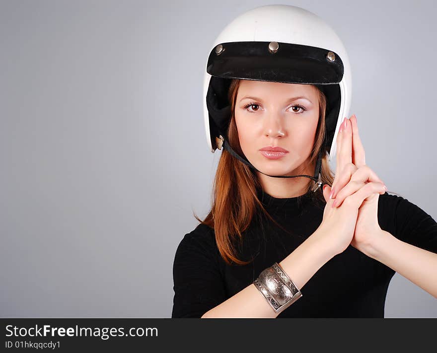 Young beautiful woman in black clothes and white helmet. Young beautiful woman in black clothes and white helmet