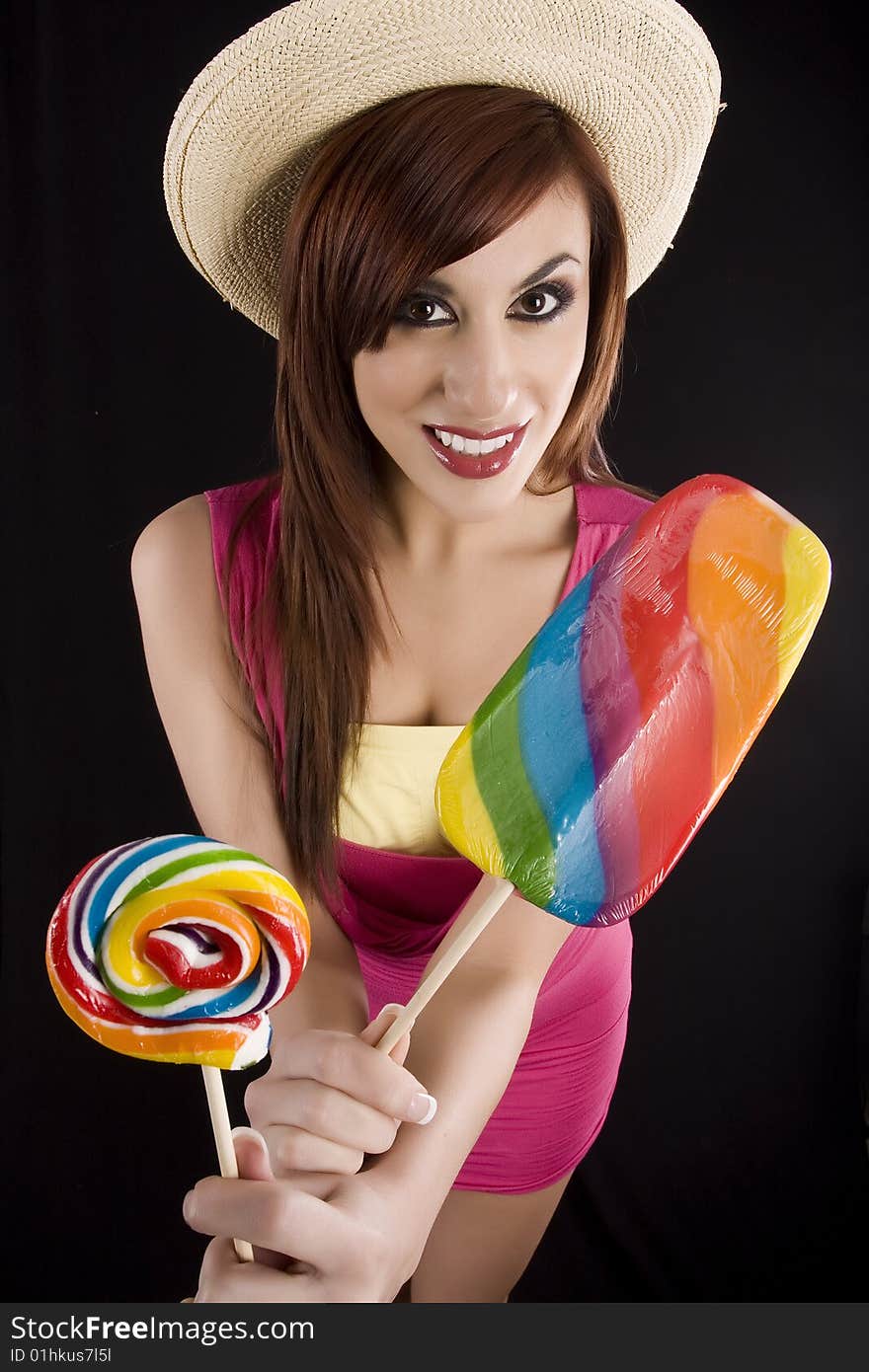 Pretty girleating a colorful sucker candy. Pretty girleating a colorful sucker candy