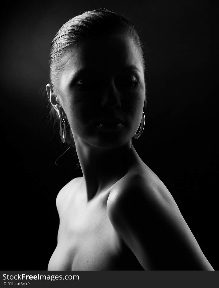 Portrait of beautiful woman at black background