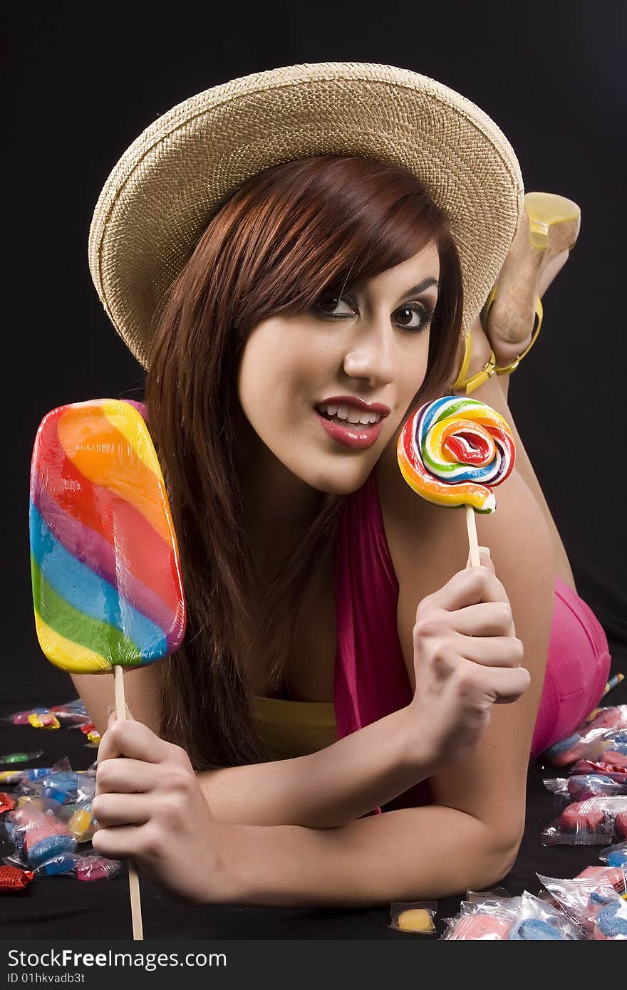 Pretty girl playing with colorful candies. Pretty girl playing with colorful candies