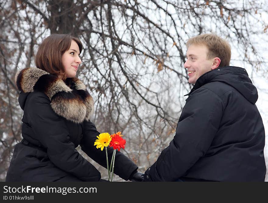 A young couple walks in the park. Winter.