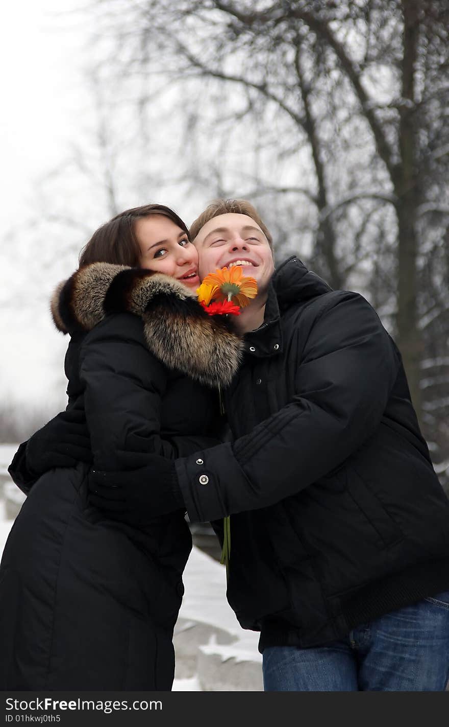 A young couple walks in the park. Winter.