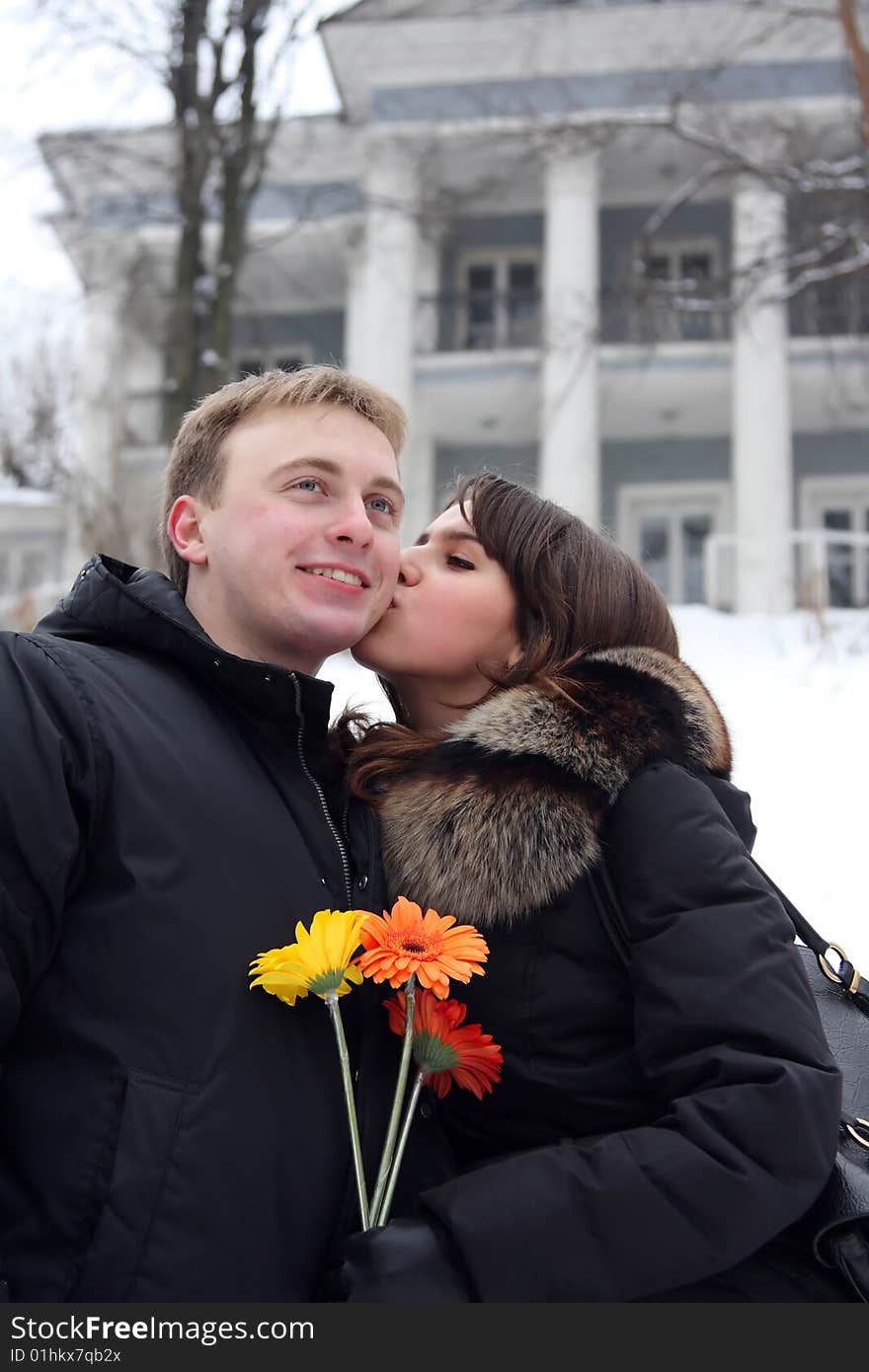 A young couple walks in the park. Winter.