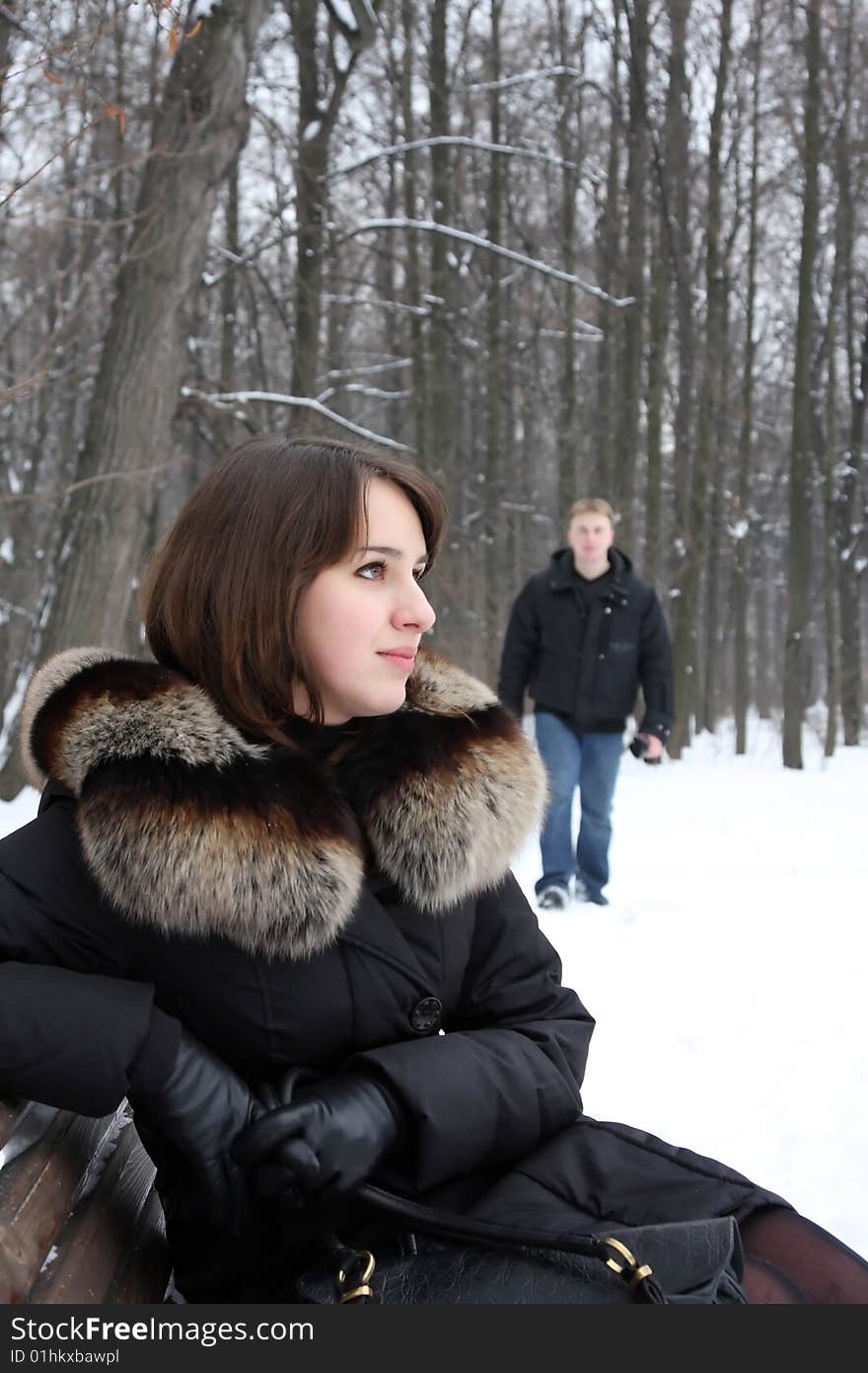 A young couple walks in the park. Winter.