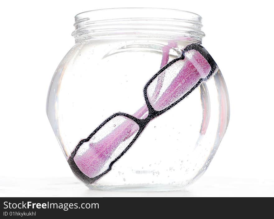 Glasses with black rim in a glass bowl with water. Glasses with black rim in a glass bowl with water