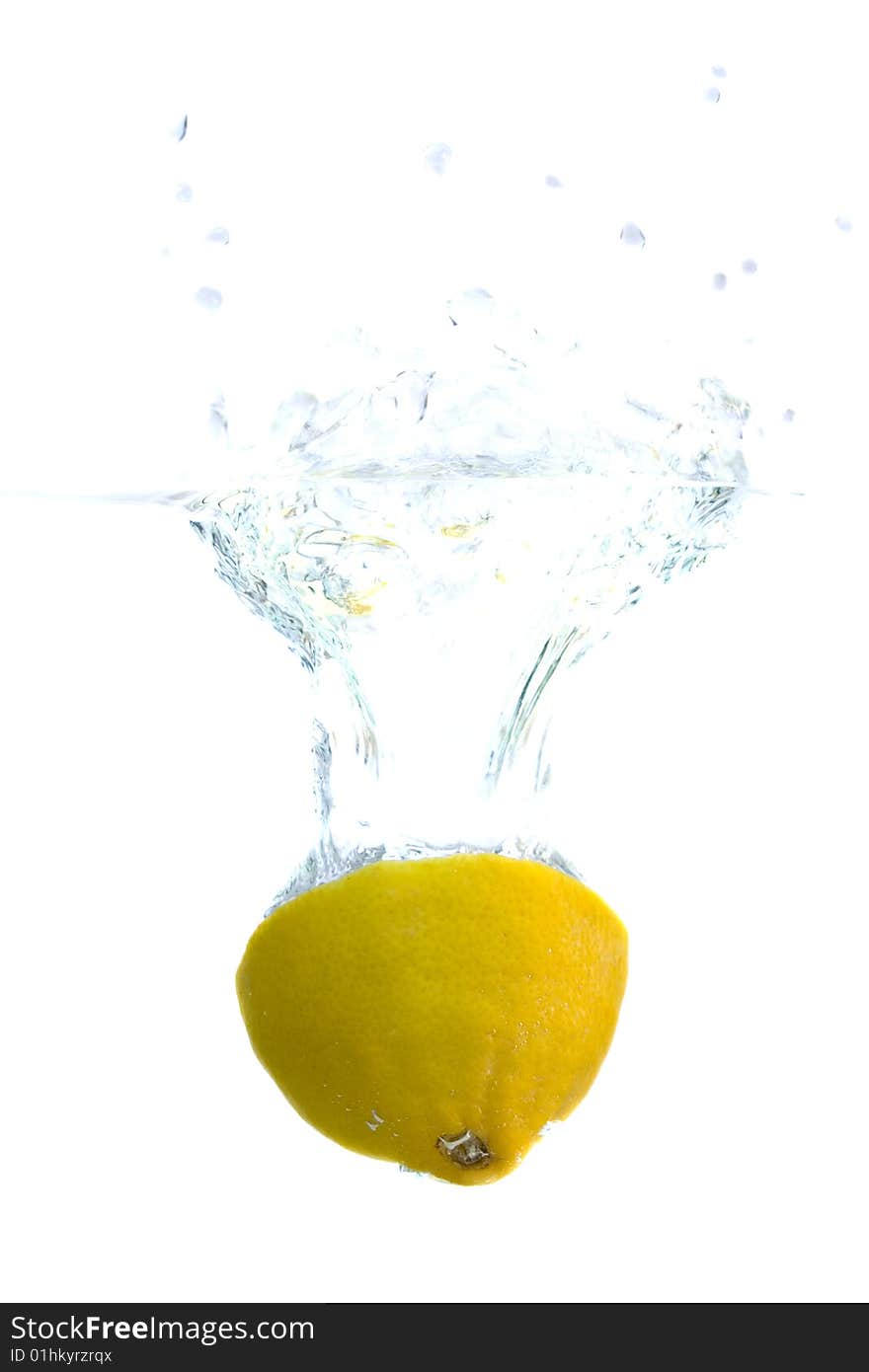 Big yellow lemon splashing in water