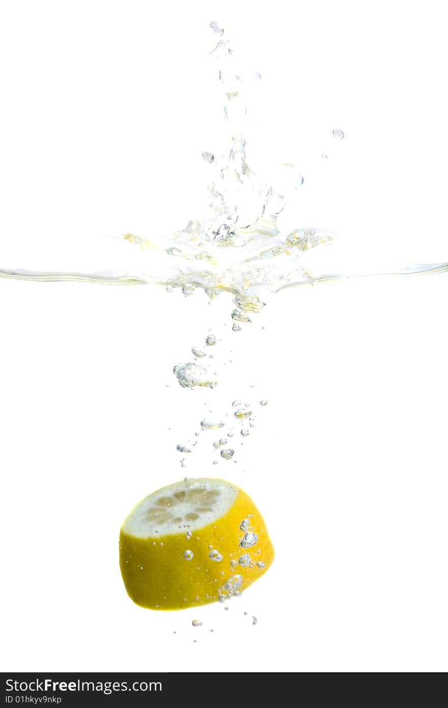 Big yellow lemon splashing in water