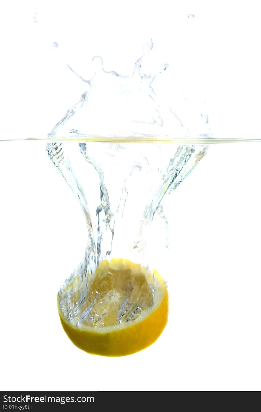 Big yellow lemon splashing in water