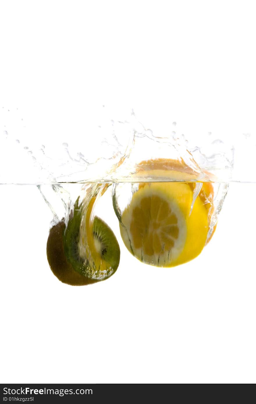 Big green kiwi and lemon splashing in water. Big green kiwi and lemon splashing in water