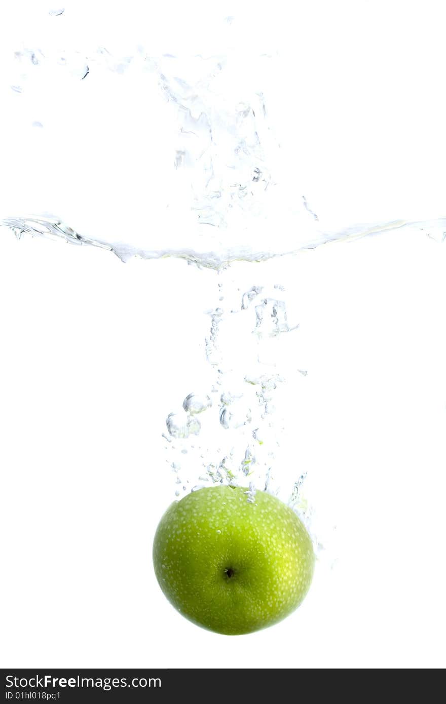 Big green apple splashing in water