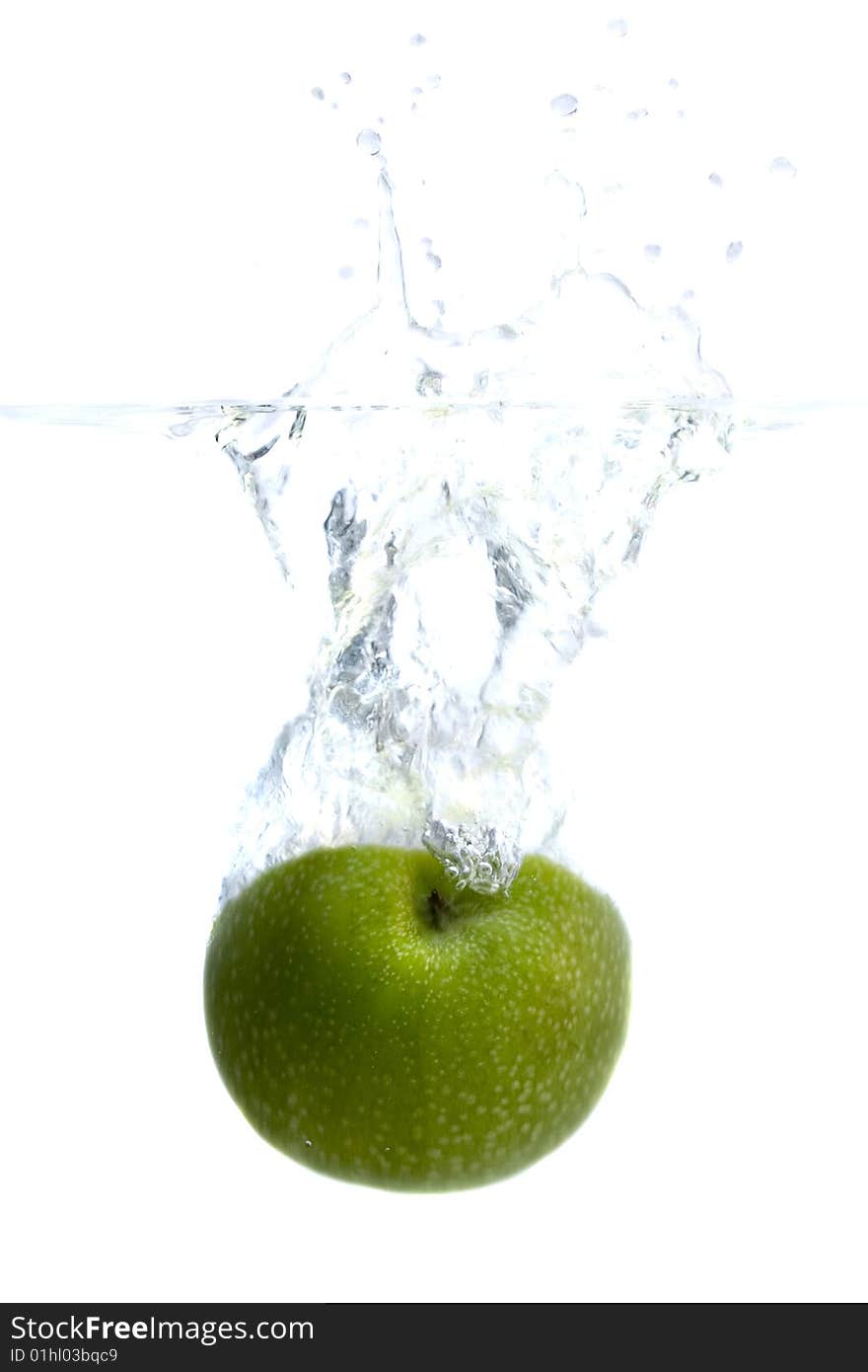 Big green apple splashing in water