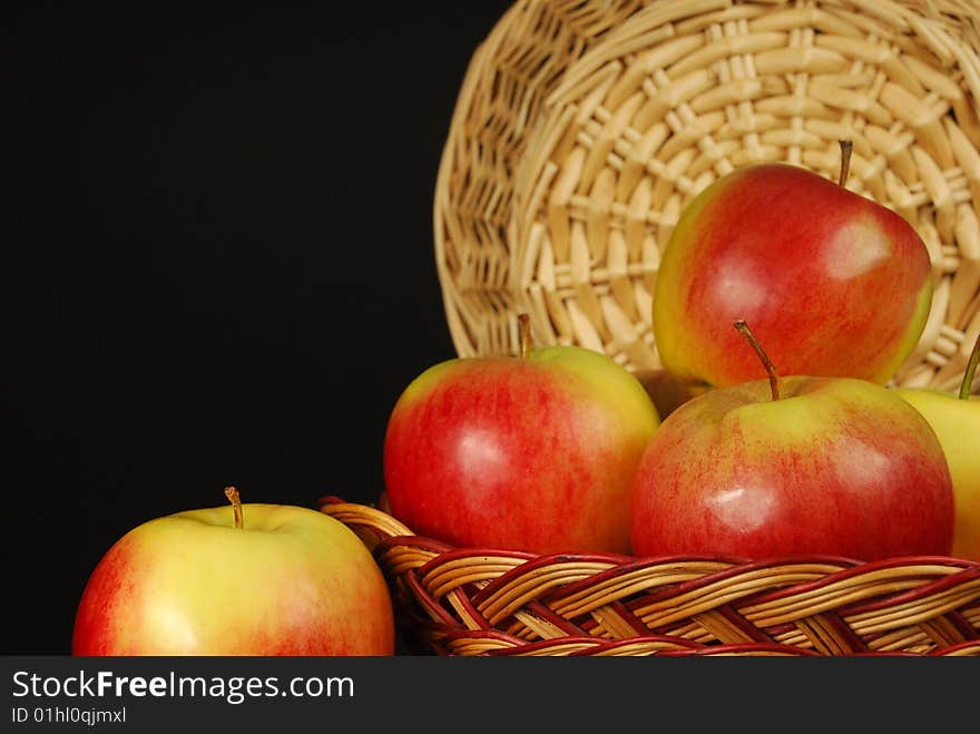 Apples in a basket on a black background