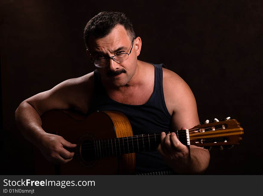 Twilight guitar playing. Black background