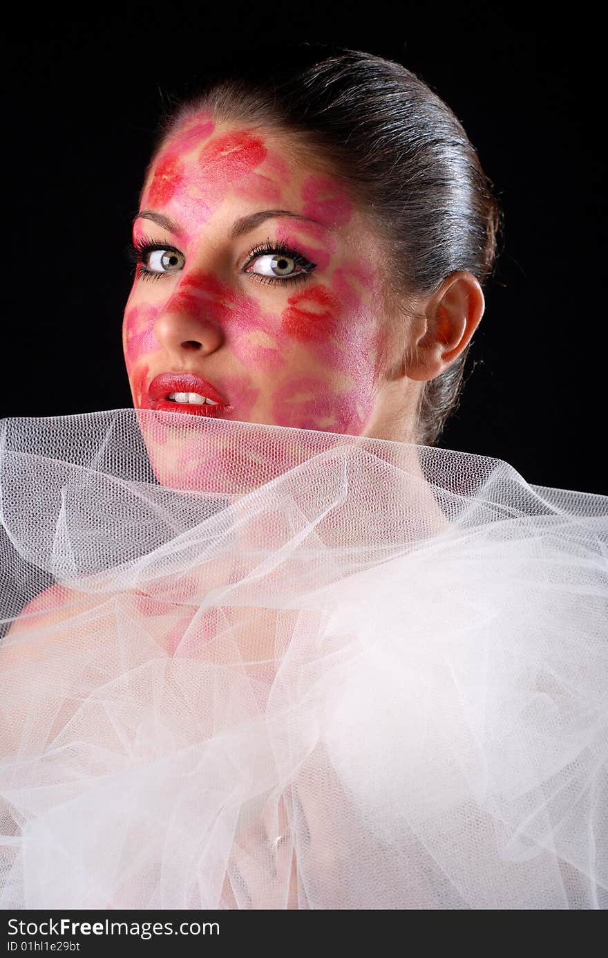 Woman with stamps of lipstick on her face and veil. Woman with stamps of lipstick on her face and veil