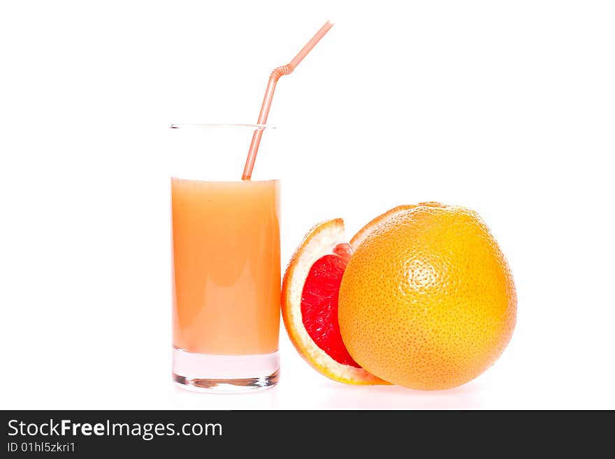 Grapefruit and juice in glass on a white background