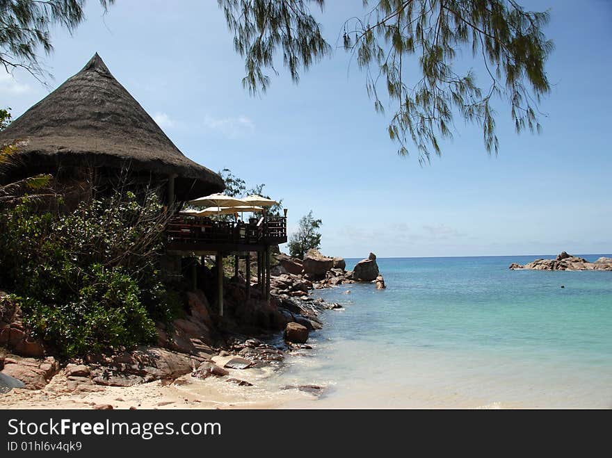 Seychelles stones and palm trees on the bank of azure ocean. Seychelles stones and palm trees on the bank of azure ocean