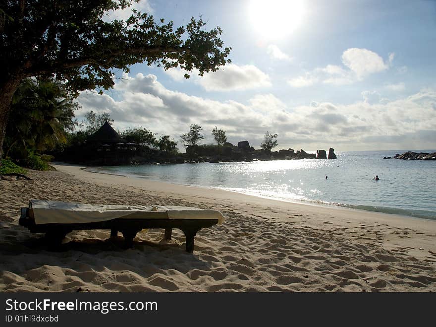 Seychelles stones and palm trees on the bank of azure ocean. Seychelles stones and palm trees on the bank of azure ocean