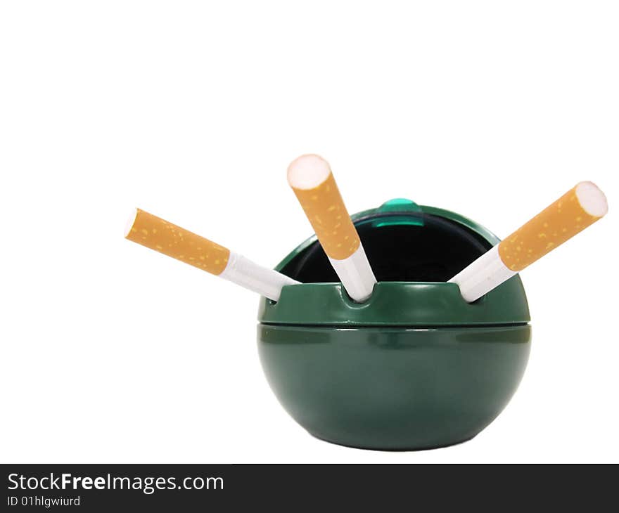 Three unlit cigarettes in an open lid ashtray. Three unlit cigarettes in an open lid ashtray.