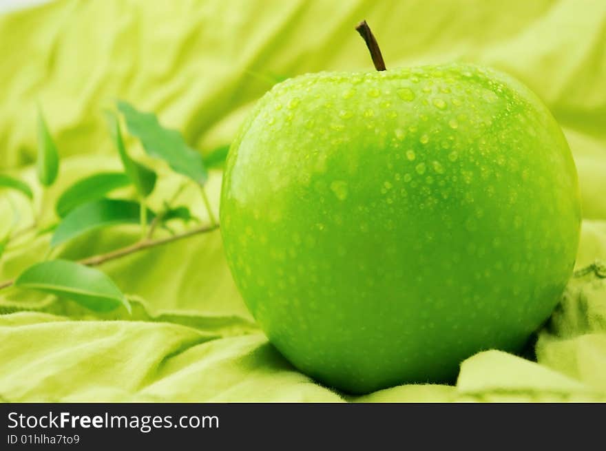 Green apple on a green background