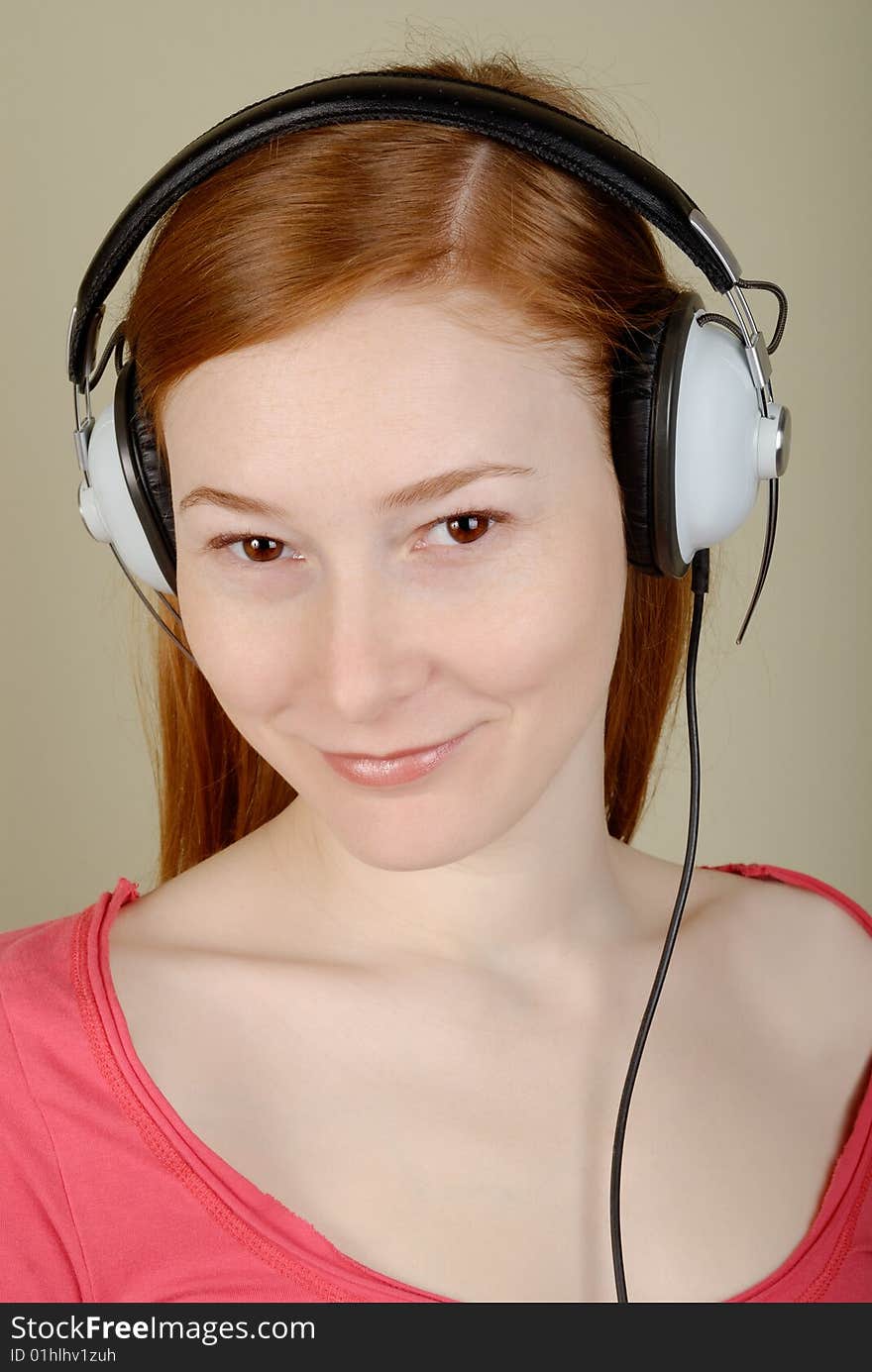 Redhead young woman in headphones