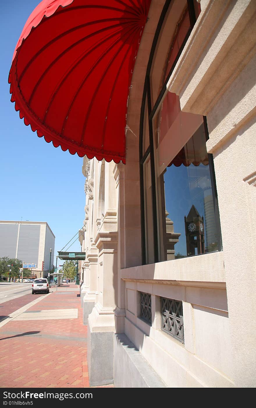 Red Parasol Shading Window with Reflection of Houston Clock Tower