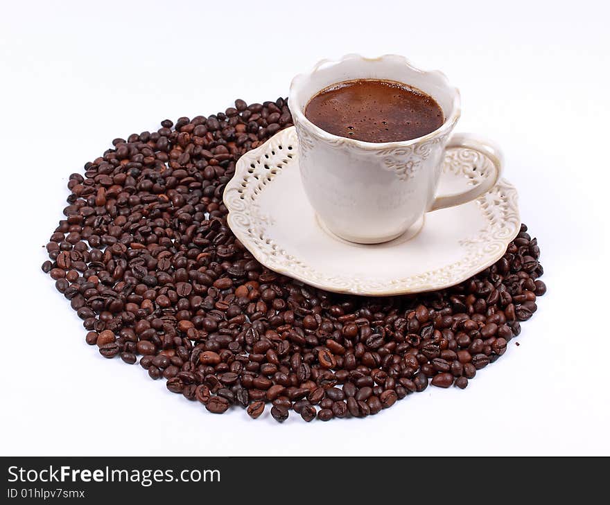 Cup of coffee and whole coffee beans isolated on white background. Cup of coffee and whole coffee beans isolated on white background