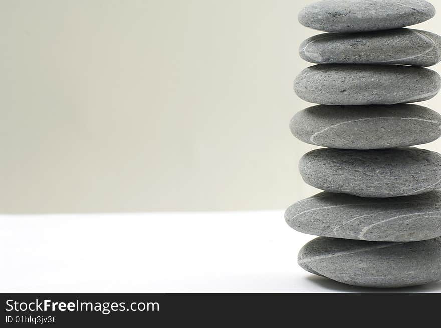 An isolated balanced stone on white