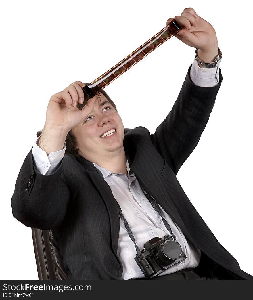 The young man looks a film on a  white background. The young man looks a film on a  white background