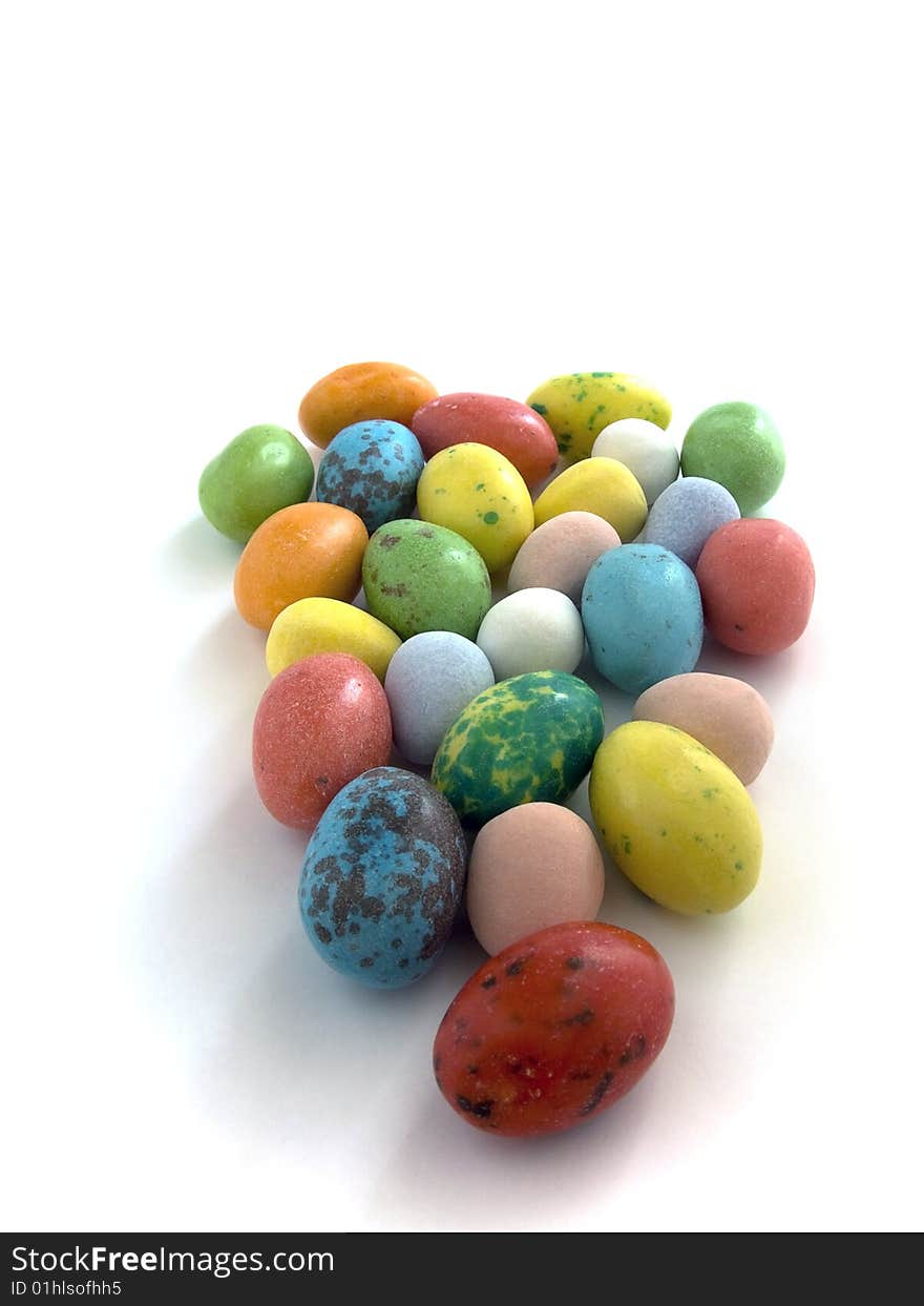 Candy coated chocolate easter eggs on white background