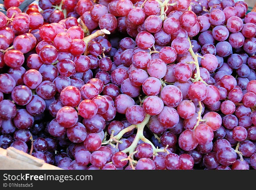 This is a shot of a fruit stand display of grapes.