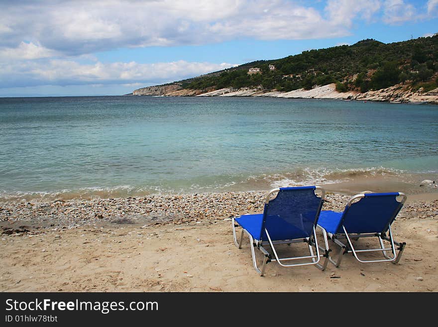 Sunbeds On Empty Beach