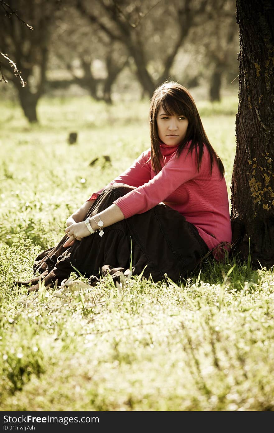 Young pensive woman in a forest. Young pensive woman in a forest.