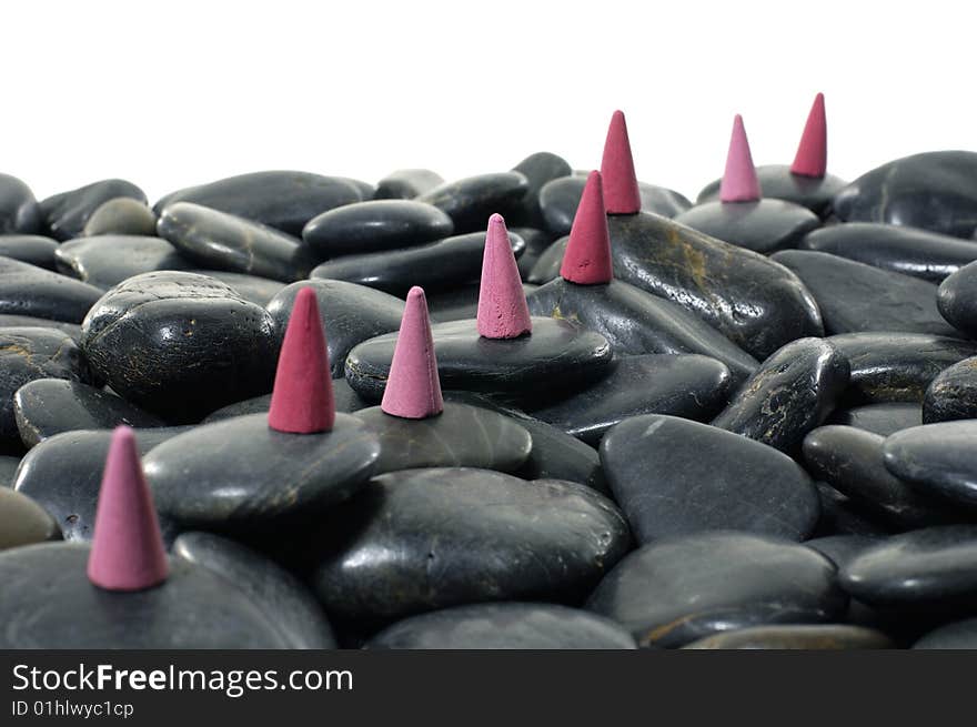 A row of incense cones on pebbles. A row of incense cones on pebbles