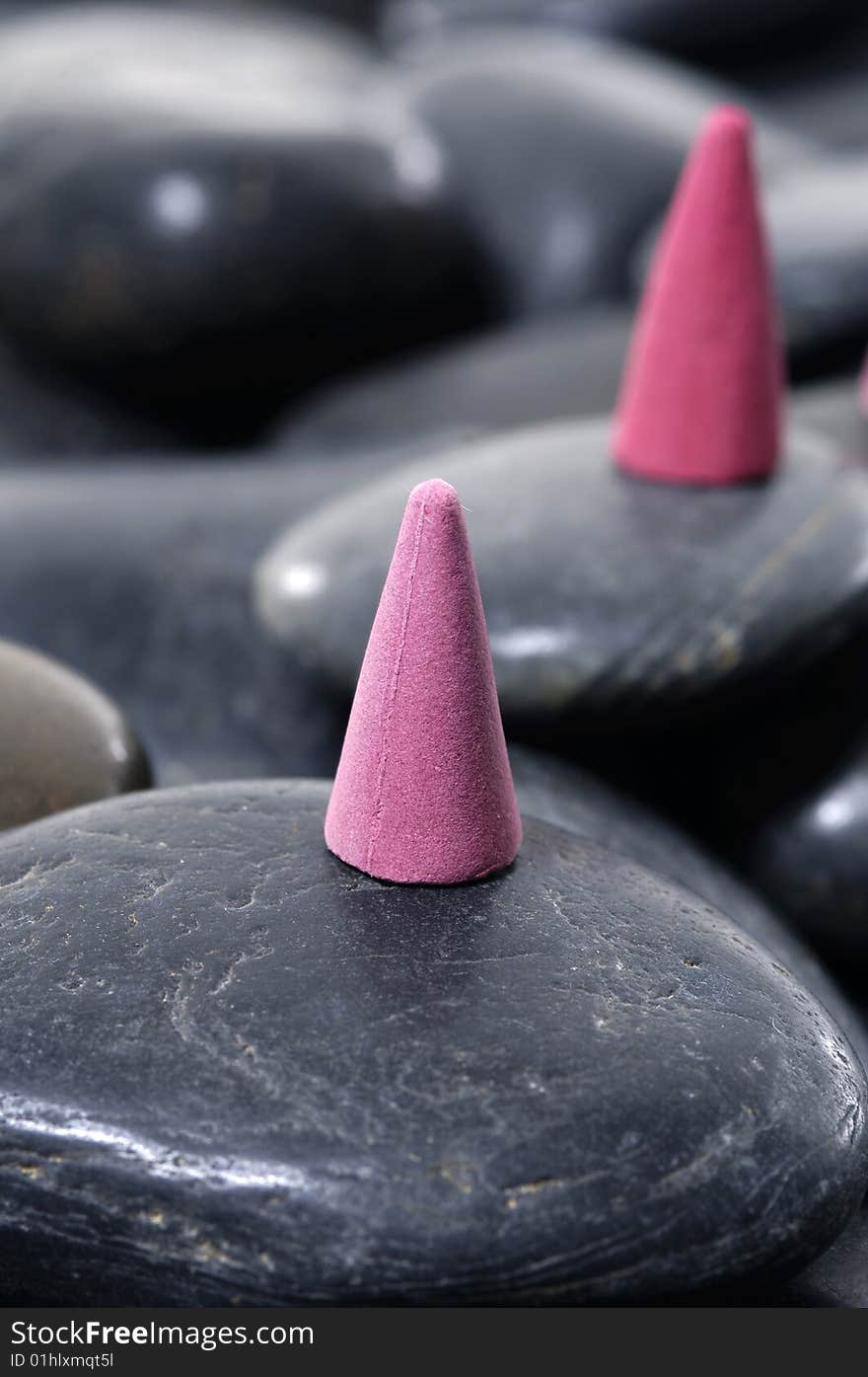 A row of incense cones on pebbles. A row of incense cones on pebbles