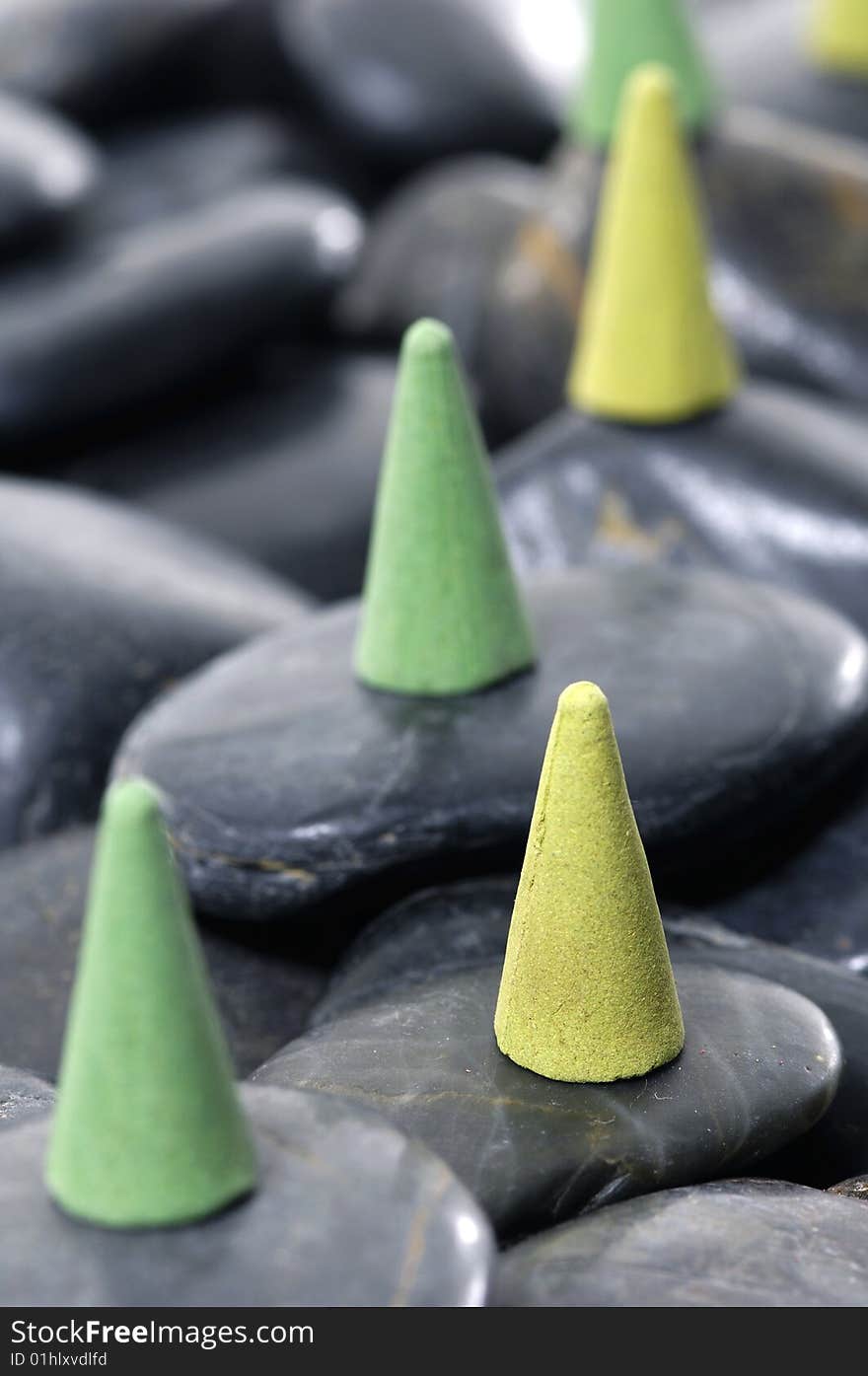 A row of incense cones on pebbles. A row of incense cones on pebbles