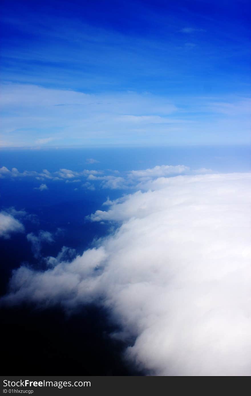 Aerial view of cloudy blue sky from aircraft window. Aerial view of cloudy blue sky from aircraft window.