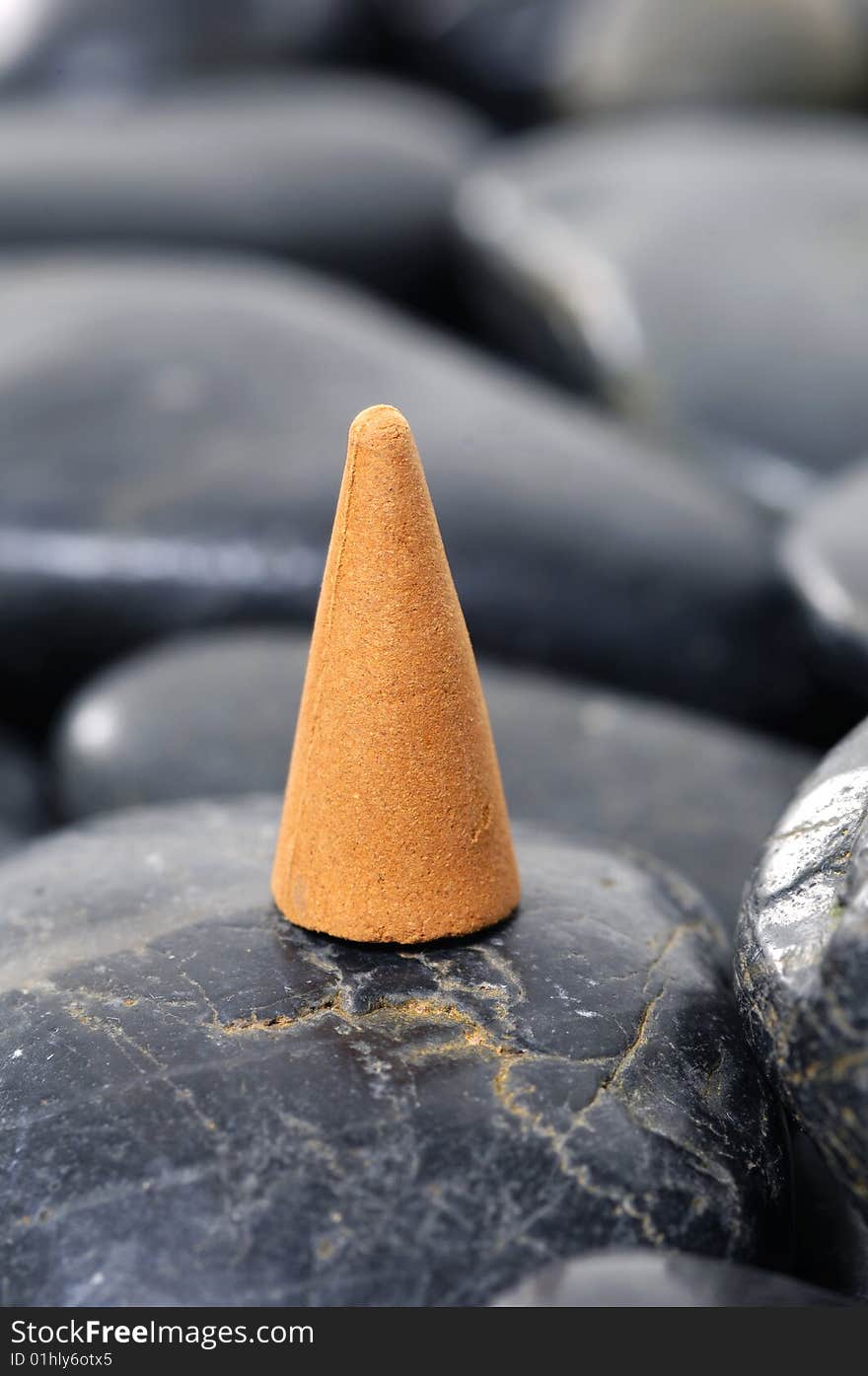 A row of incense cones on pebbles. A row of incense cones on pebbles