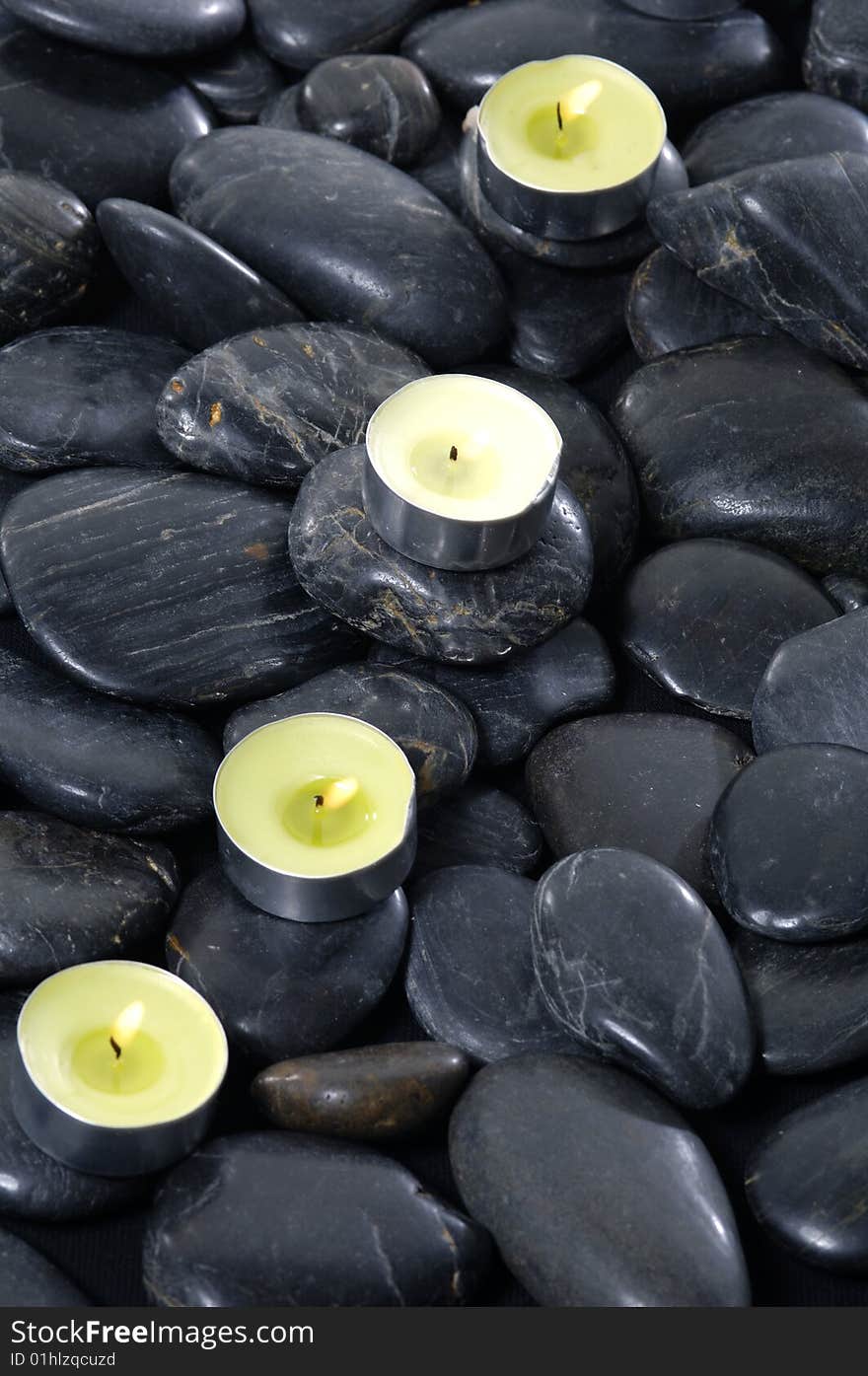 Alight candles and pebbles for spa session. Alight candles and pebbles for spa session