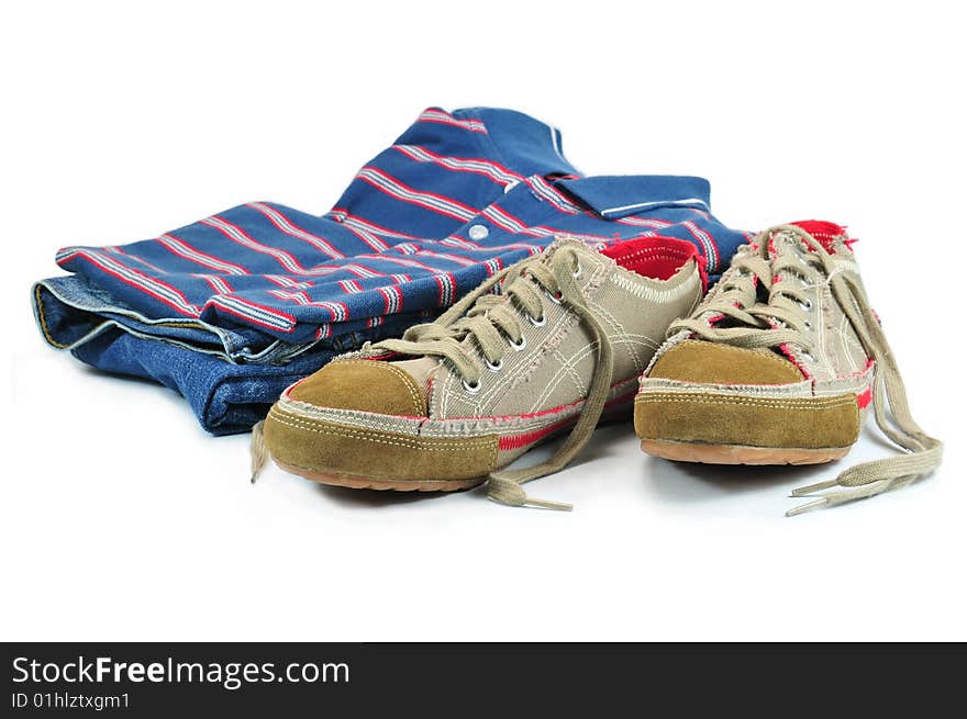 Blue Jeans, colorful T-Shirt and Sneakers isolated on white background. Blue Jeans, colorful T-Shirt and Sneakers isolated on white background