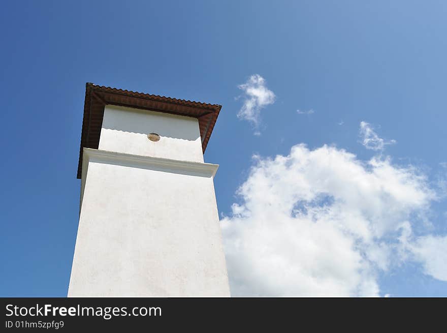 Tower of a catholic church against a blue sky. Tower of a catholic church against a blue sky