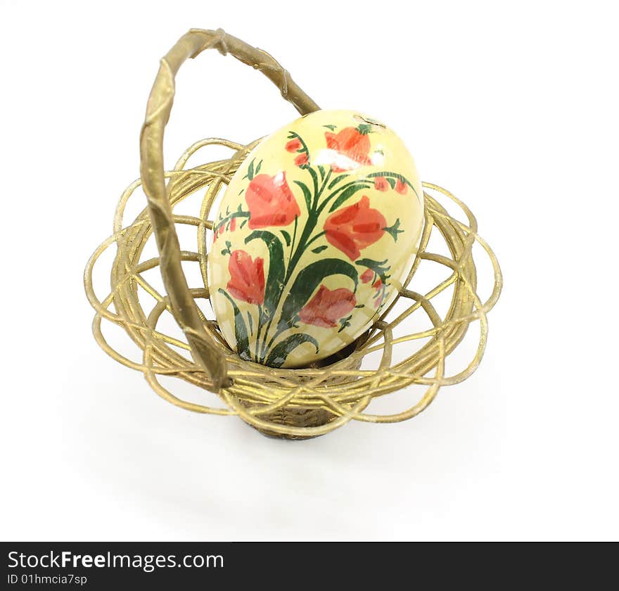 Antique Easter egg and basket isolated on a white background.