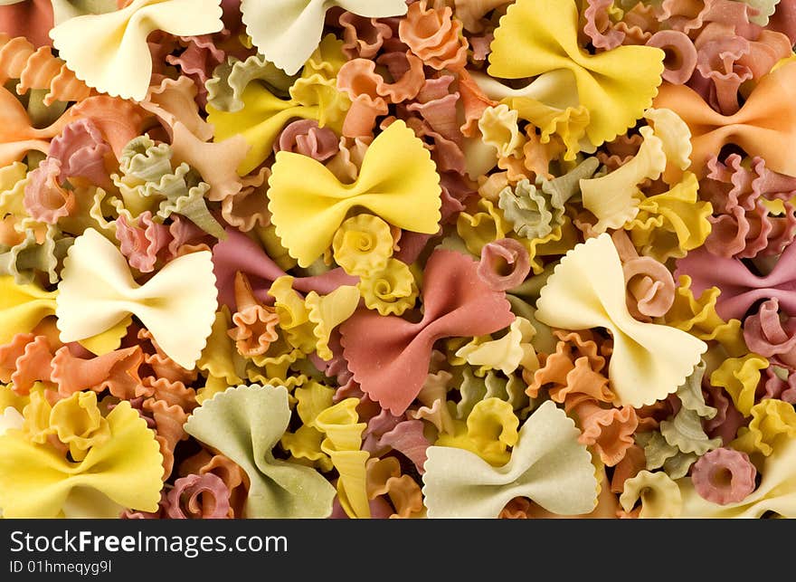 Colorful bow and spiral shaped vegetable pasta macro