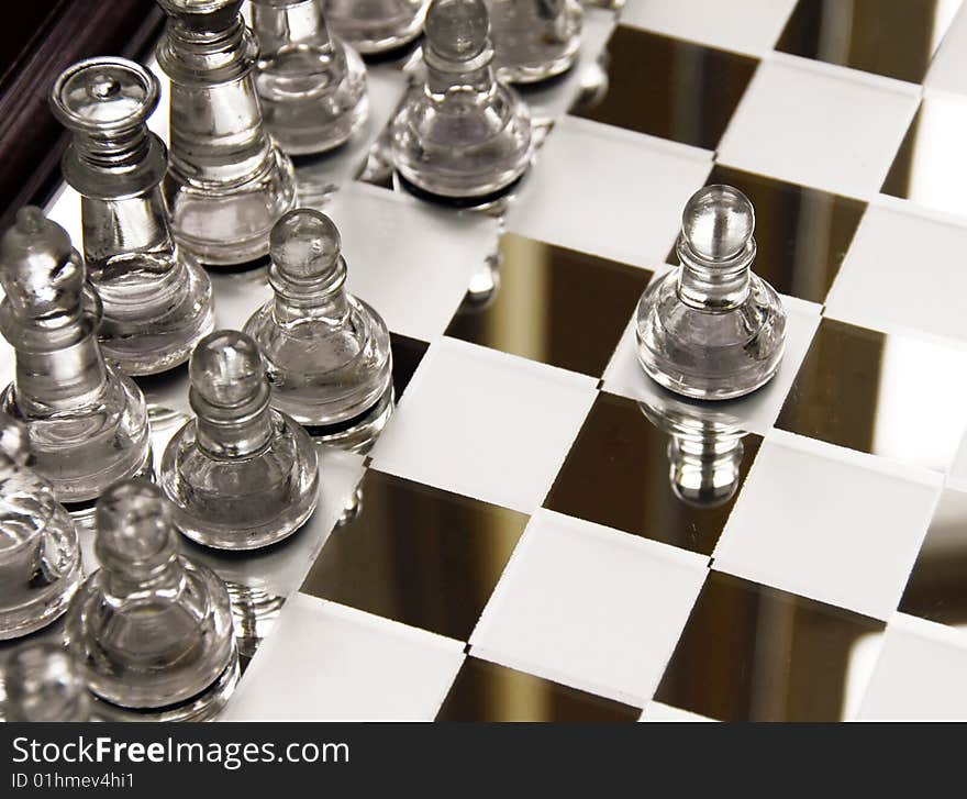 Glass chessboard with first beginning position of pawn