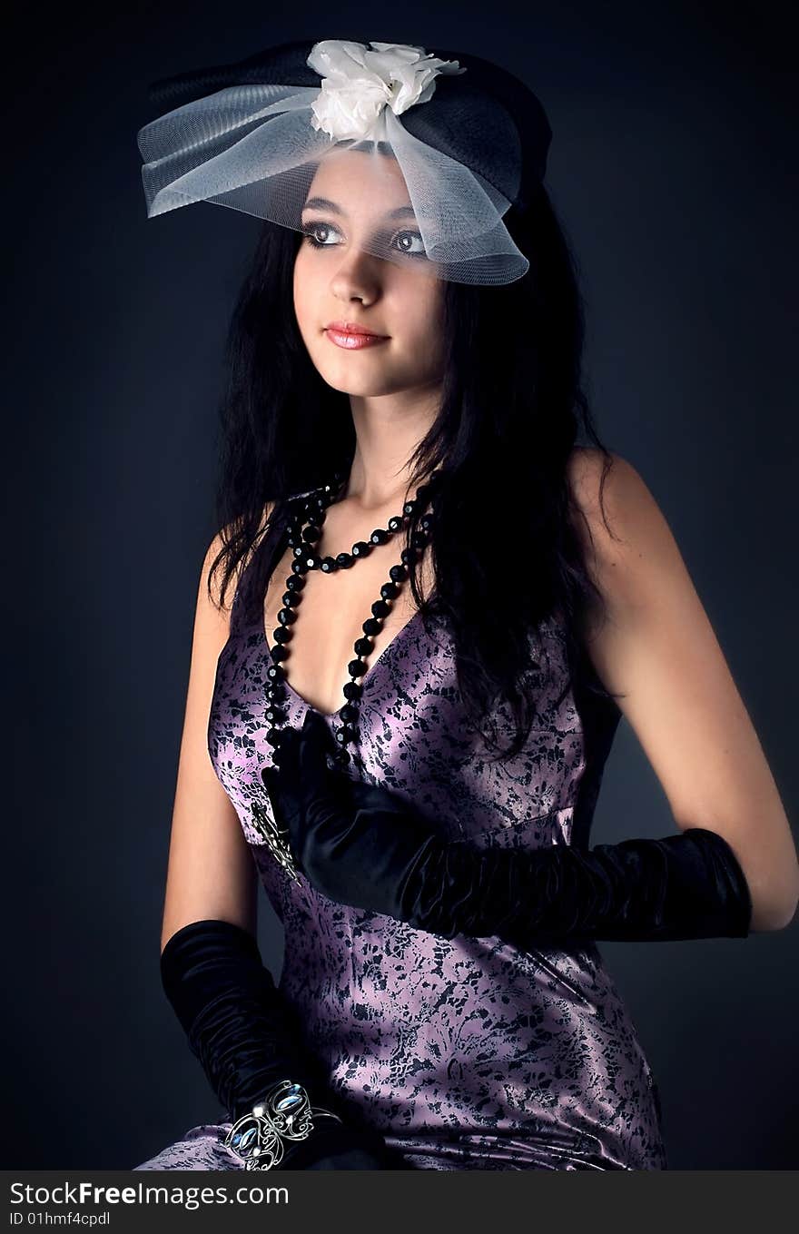 Series. Portrait of the beautiful brunette in a dark blue dress