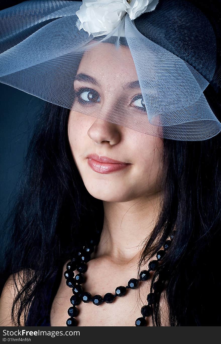 Series. Portrait of the beautiful brunette in a dark blue dress