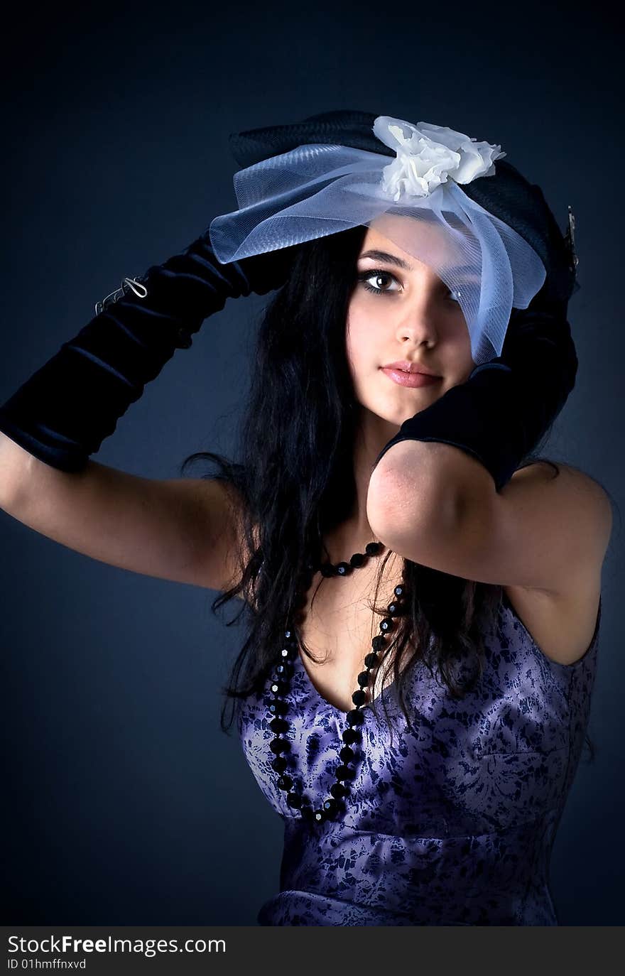 Series. Portrait of the beautiful brunette in a dark blue dress