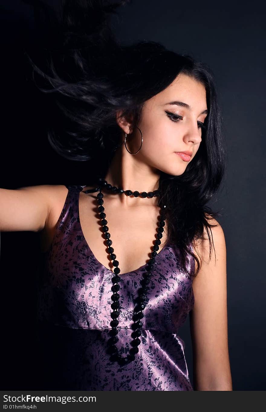 Series. Portrait of the beautiful brunette in a dark blue dress