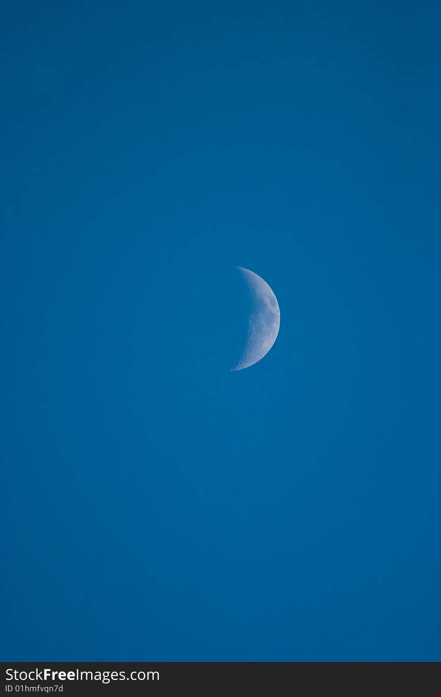 White moon at sunny day on blue sky