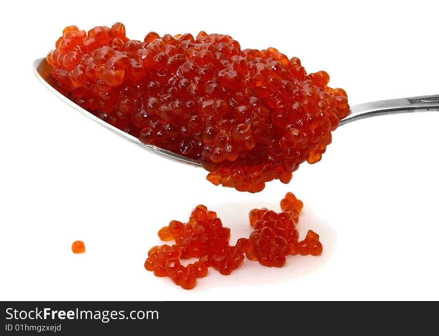 Red caviar on a spoon over white background. Red caviar on a spoon over white background